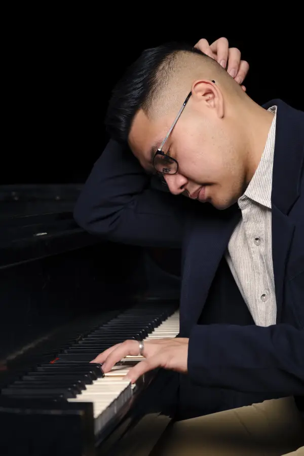 Isaac bent over the keys, deep in the music
