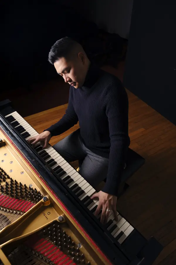 Overhead view of hands on a piano keyboard
